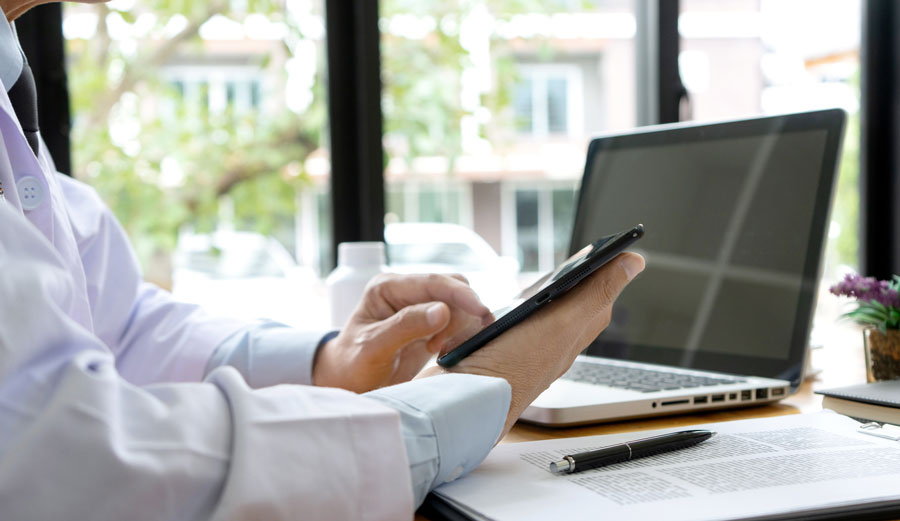 telemedicine physician looking at devices